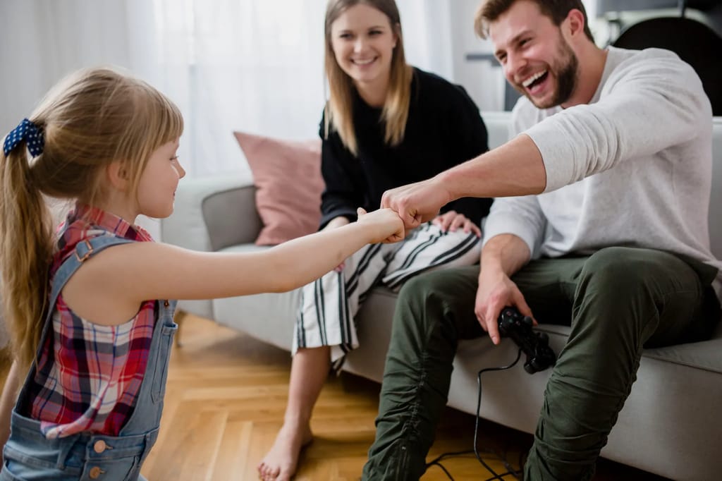 Parent and child playing together in a sunlit playroom