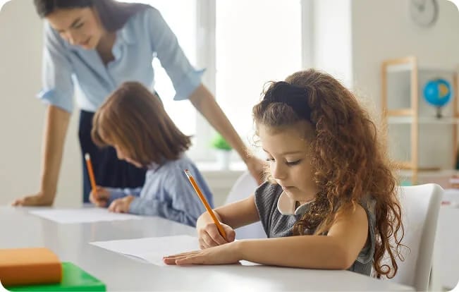 Children drawing with adult support