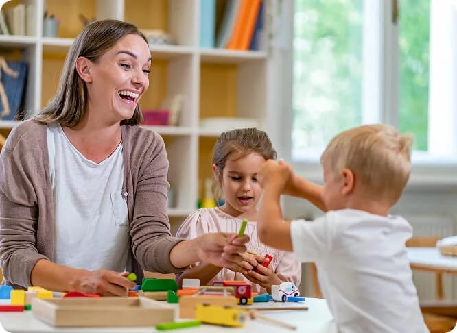 Adult supporting children during a play activity