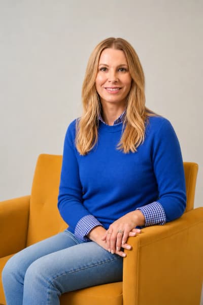 Portrait of Dr. Kate, founder of The Behavior Project, seated in a clinic chair