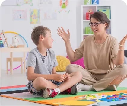 Adult supporting a child during a communication activity