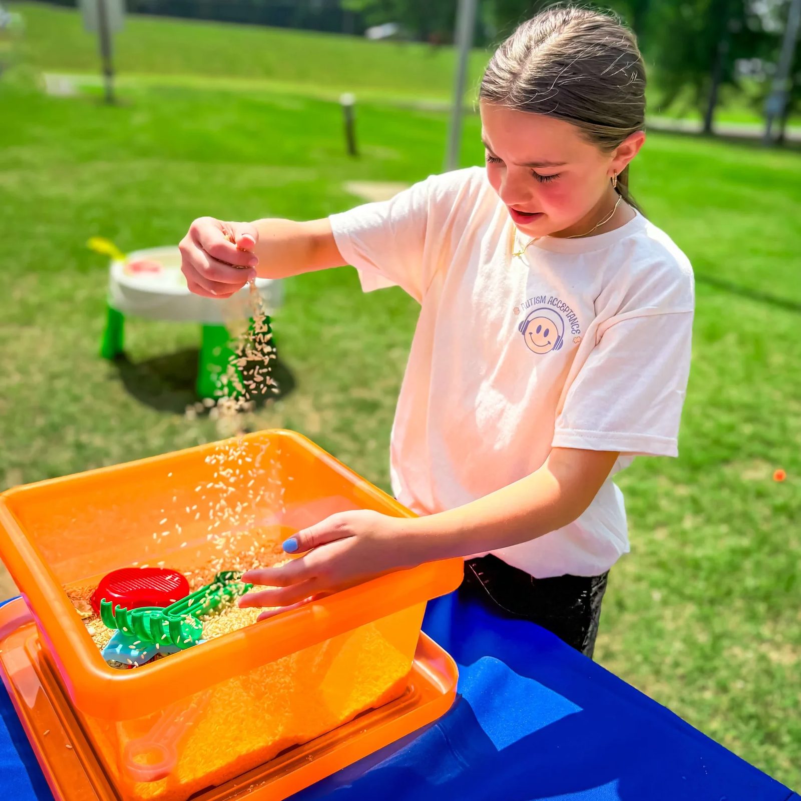 Child playing with a sensory activity outdoors