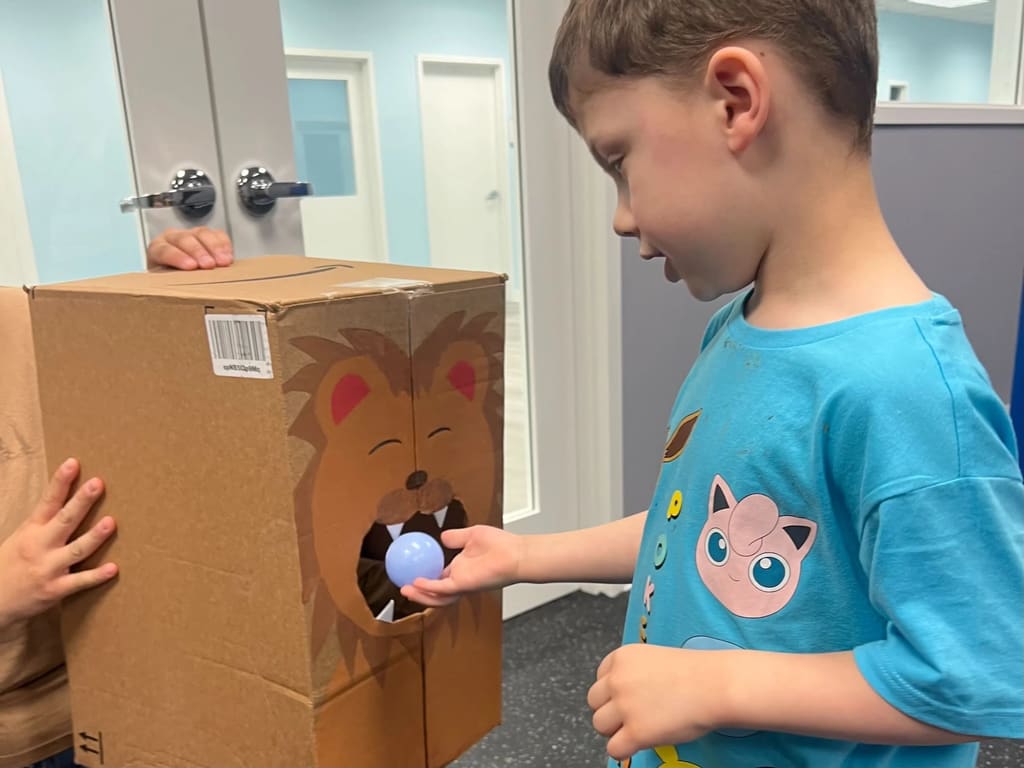 Child playing with sensory box during ABA session