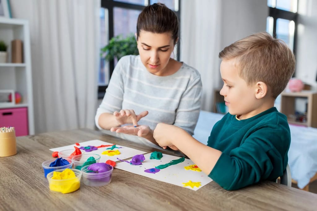 Adult and child use colorful modeling clay at a table