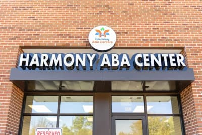 Exterior entrance and sign for Harmony ABA Centers in Katy, Texas