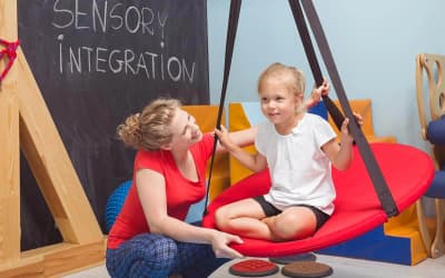 Therapist supporting a child during a sensory activity